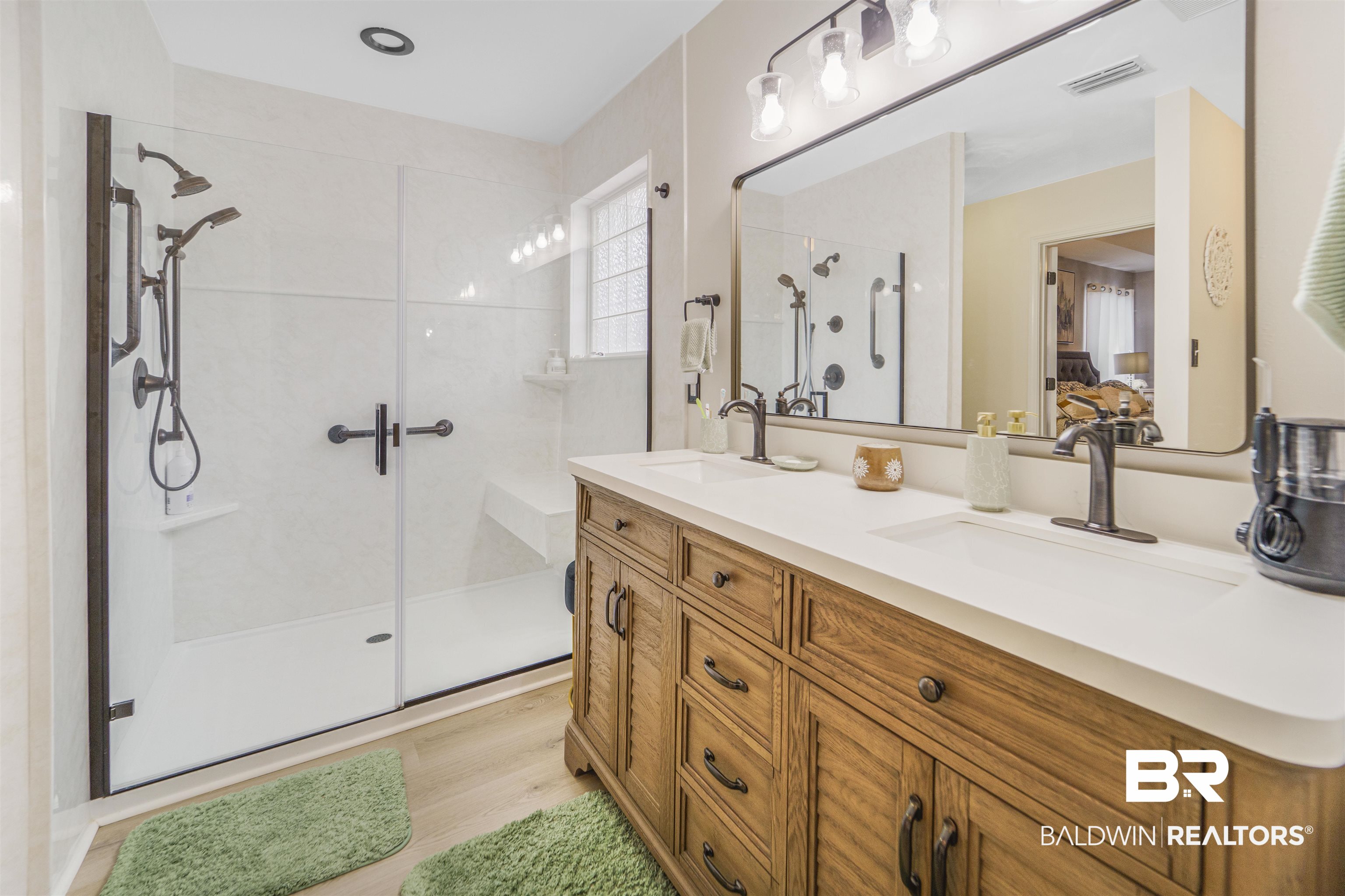 4620 Pine Boulevard Orange Beach, AL 36561 - Photo 17 of 49 Ensuite bathroom featuring a shower stall, double vanity, and wood finished floors