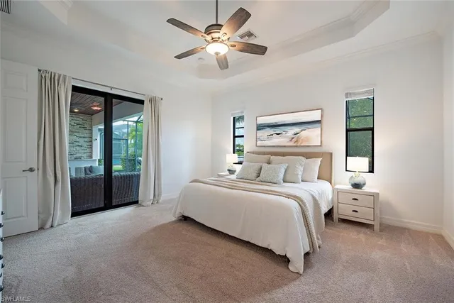 a spacious bedroom with a bed and a large window