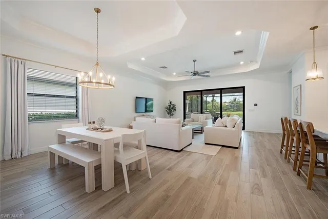 a living room with furniture or chandelier and a wooden floor