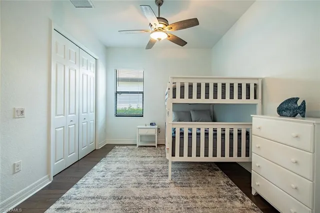 a bedroom with a baby crib and a window