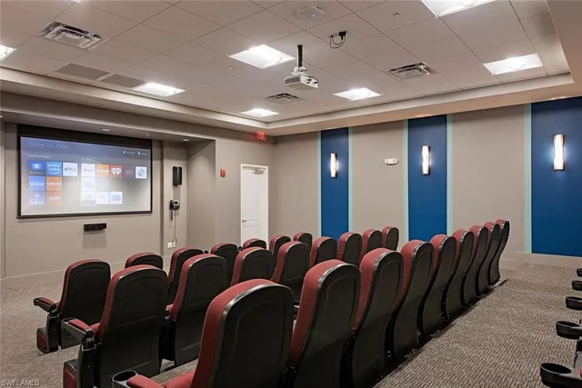 a media room with lots of chairs and a projector screen