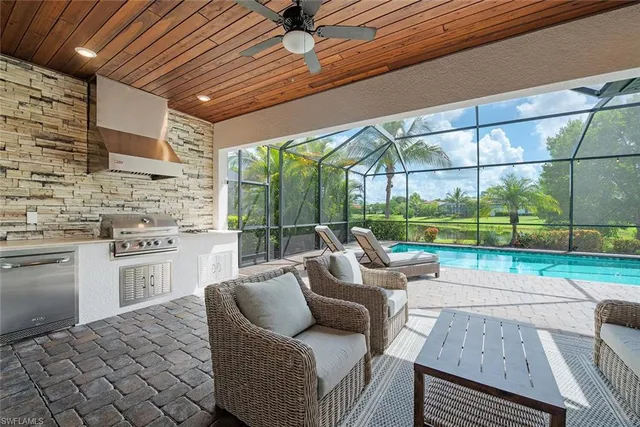 a living room with patio furniture and a yard