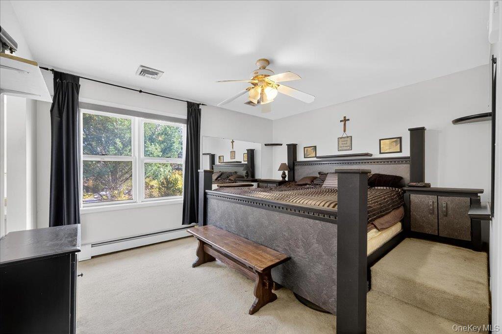 74 Pocatello Road Middletown, NY 10940 - Photo 13 of 21 Bedroom with light colored carpet, a baseboard radiator, and ceiling fan