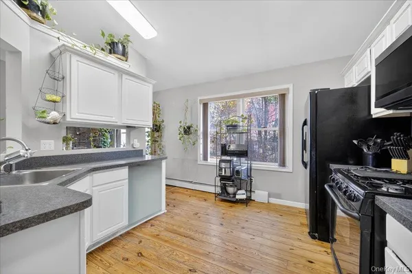 a kitchen with granite countertop a sink stove and refrigerator