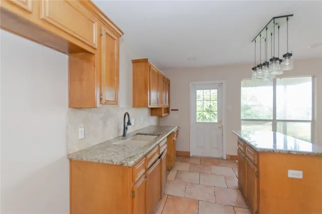 a kitchen that has a sink and a window in it