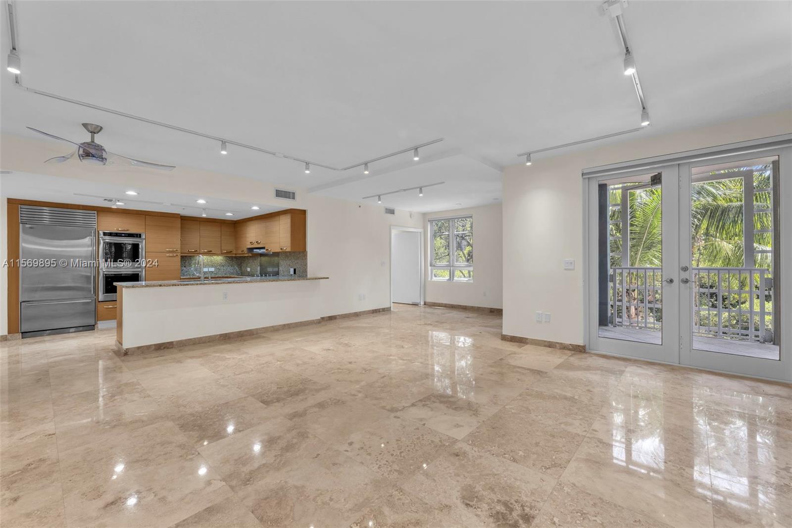 3540 Main Highway, Unit 310 Miami, FL 33133 - Photo 1 of 47 a view of an empty room with a window and kitchen view