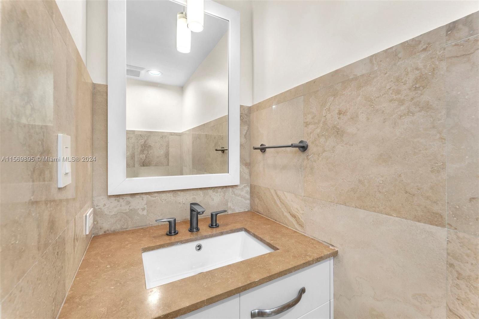 3540 Main Highway, Unit 310 Miami, FL 33133 - Photo 25 of 47 a bathroom with a sink and a mirror