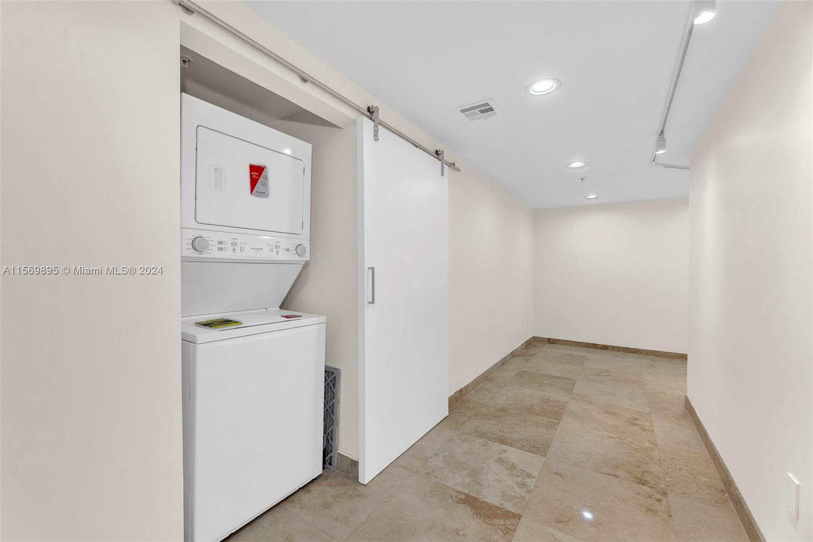 3540 Main Highway, Unit 310 Miami, FL 33133 - Photo 26 of 47 a view of storage and utility room with washer and dryer