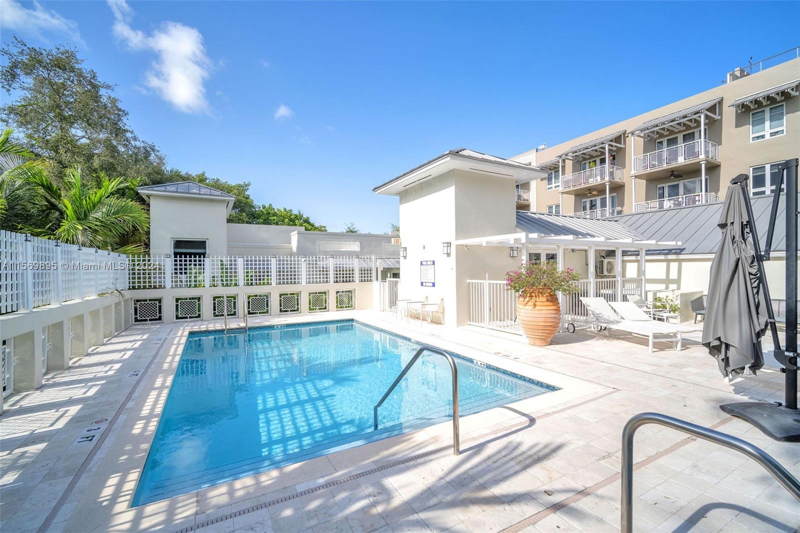 3540 Main Highway, Unit 310 Miami, FL 33133 - Photo 30 of 47 a view of a building with a swimming pool