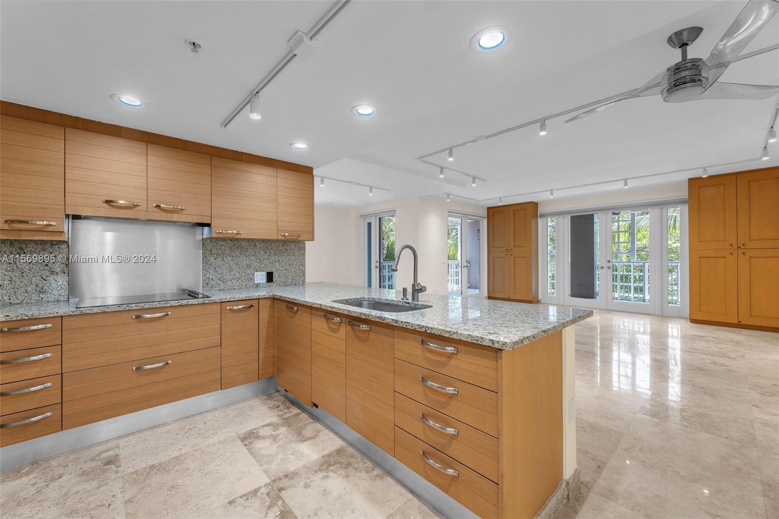 3540 Main Highway, Unit 310 Miami, FL 33133 - Photo 3 of 47 a kitchen with granite countertop a sink and cabinets
