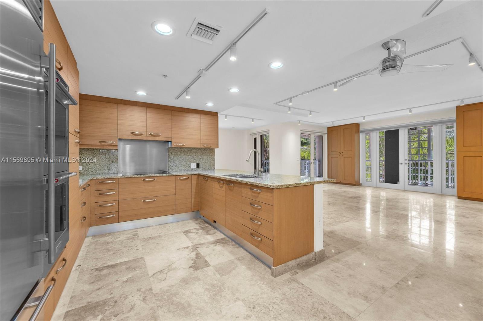 3540 Main Highway, Unit 310 Miami, FL 33133 - Photo 4 of 47 a large kitchen with stainless steel appliances a large counter top