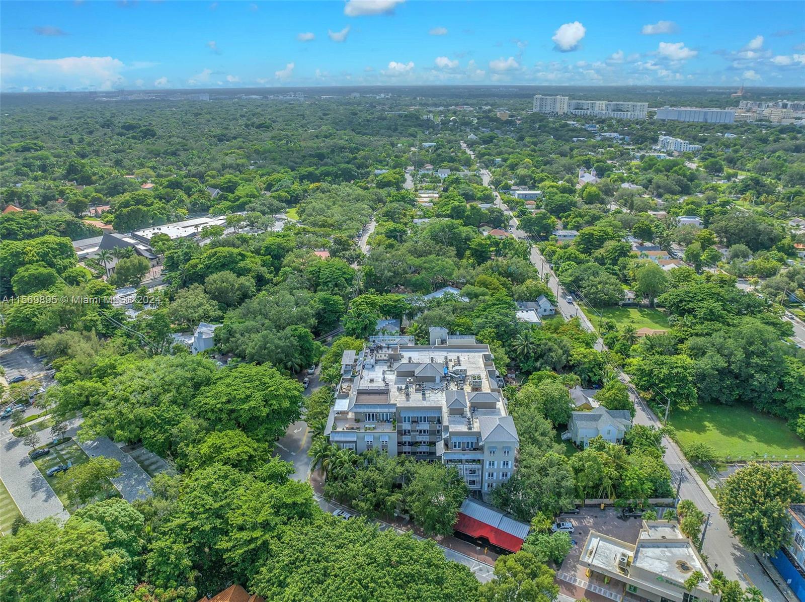 3540 Main Highway, Unit 310 Miami, FL 33133 - Photo 45 of 47 an aerial view of residential houses with outdoor space and trees