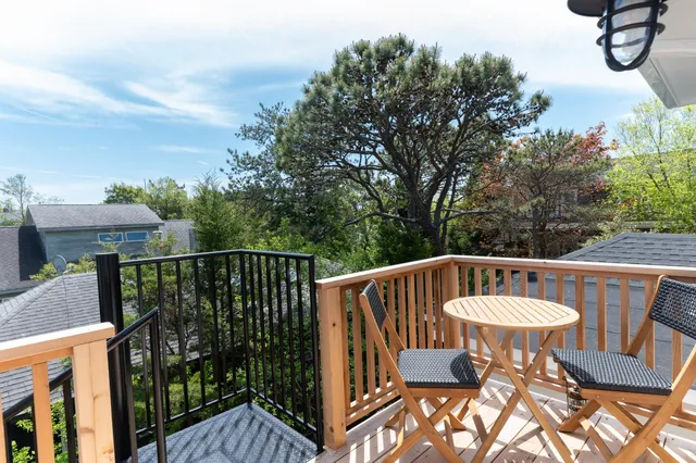 a view of a roof deck with furniture