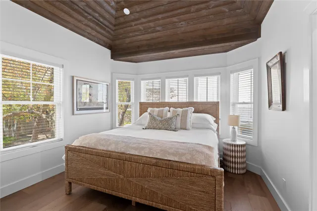 a room with a bed and wooden floor