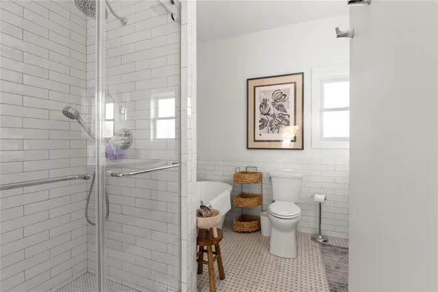 a bathroom with a toilet and a shower