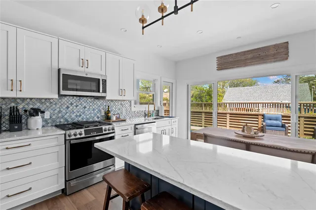 a kitchen with a stove a sink and a microwave