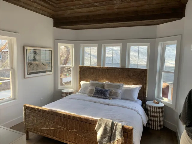 a bedroom with a bed and window
