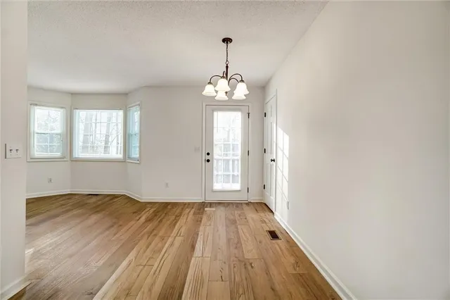 a view of a room with wooden floor and windows