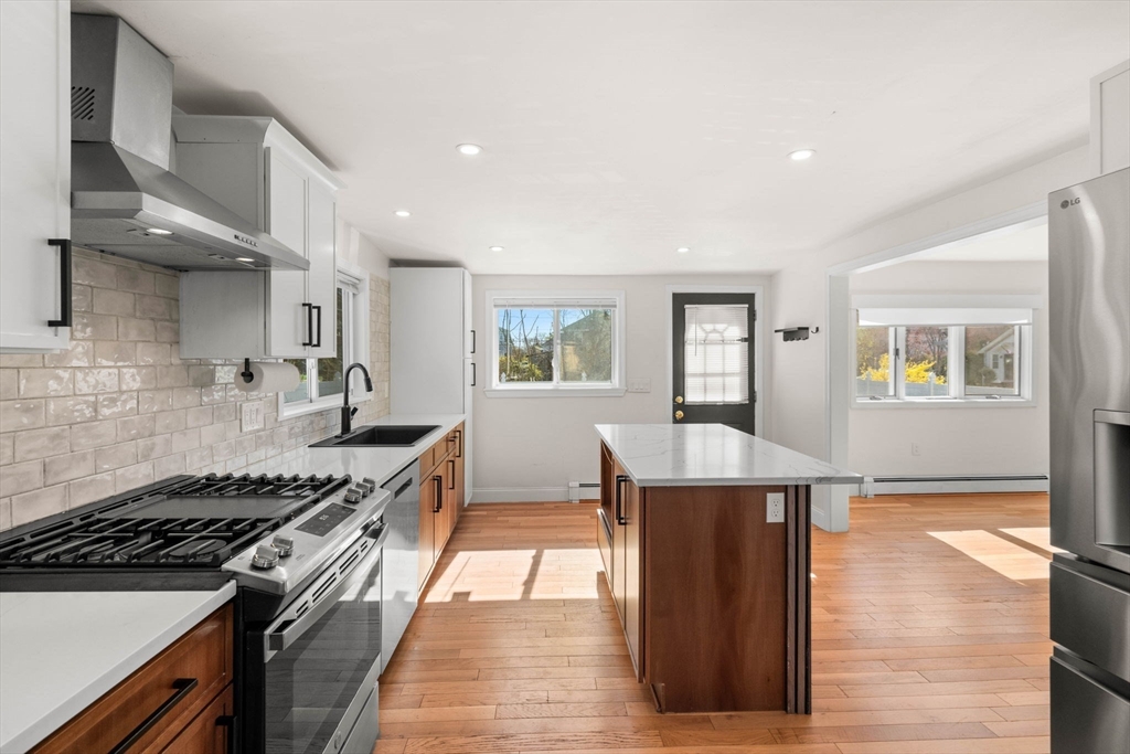 271 Broadway Haverhill, MA 01832 - Photo 16 of 41 a kitchen with stainless steel appliances granite countertop a stove and a refrigerator
