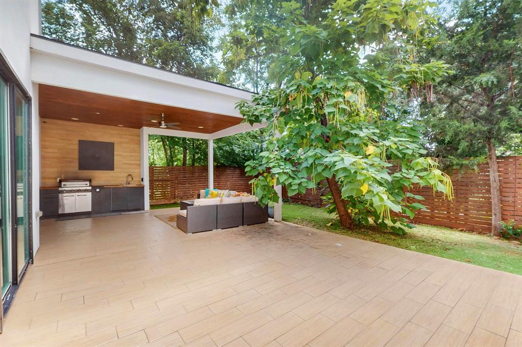 3946 North Cresthaven Road Dallas, TX 75209 - Photo 37 of 38 Spacious outdoor patio featuring wood-finish ceiling, built-in outdoor kitchen with grill and sink, ceiling fan, and sliding glass doors