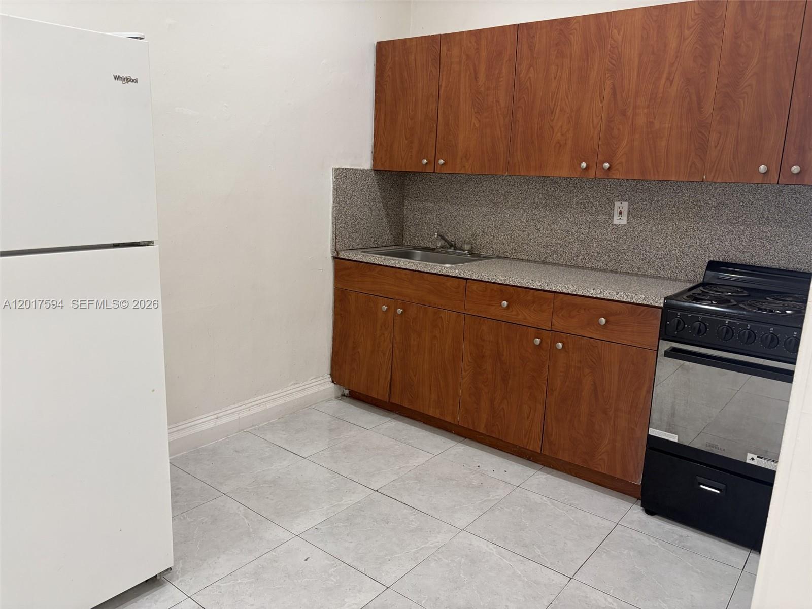 4701 Southwest 8th Street, Unit 6 Miami, FL 33134 - Photo 2 of 4 a kitchen with a sink and cabinets