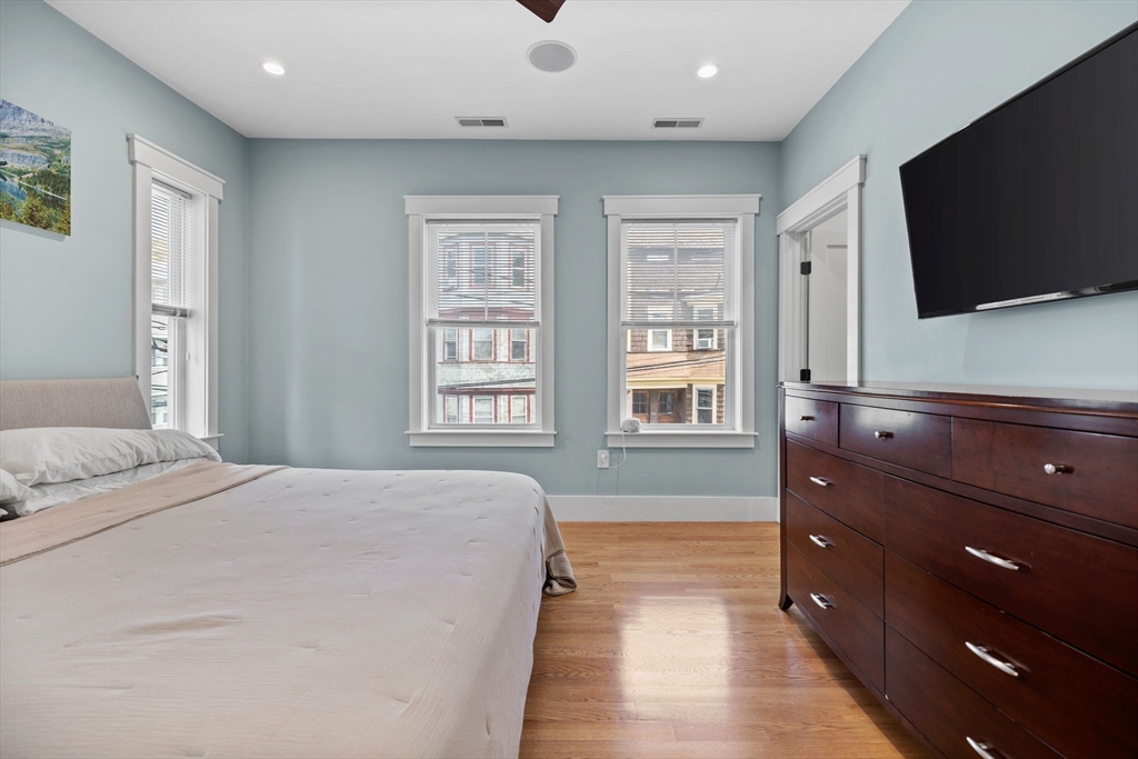 11 Ashland Street, Unit 2 Boston, MA 02122 - Photo 12 of 34 a spacious bedroom with a bed and a flat screen tv