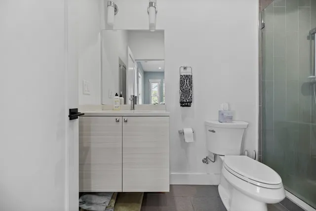 a white toilet sitting next to a bath tub