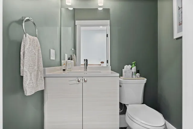 a roof deck with couches and wooden floor