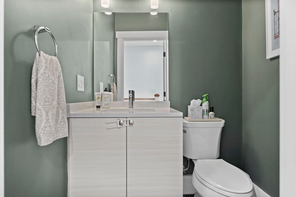 11 Ashland Street, Unit 2 Boston, MA 02122 - Photo 22 of 34 a bathroom with a toilet sink and mirror
