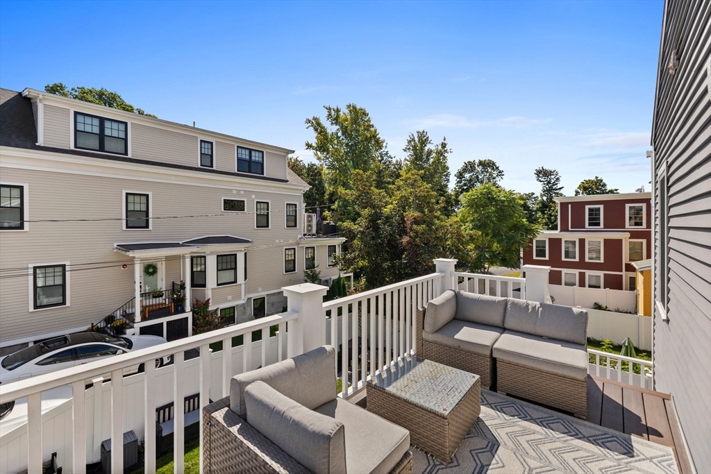 11 Ashland Street, Unit 2 Boston, MA 02122 - Photo 23 of 34 a roof deck with couches and wooden floor