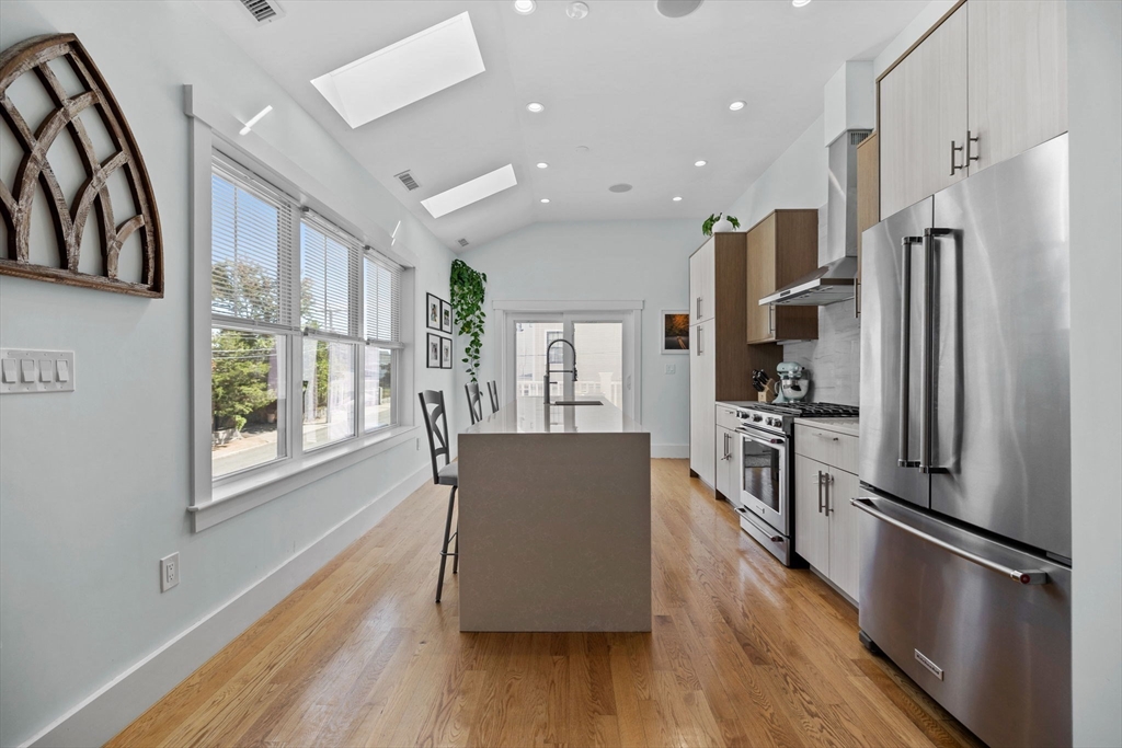 11 Ashland Street, Unit 2 Boston, MA 02122 - Photo 3 of 34 a living room with stainless steel appliances furniture wooden floor and a large window