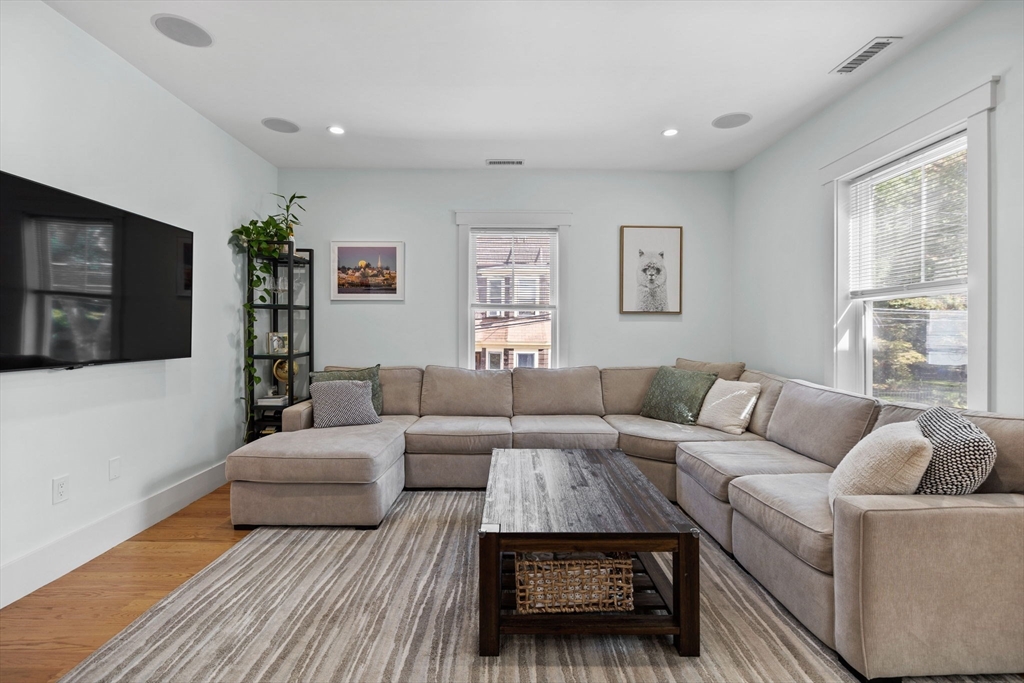 11 Ashland Street, Unit 2 Boston, MA 02122 - Photo 6 of 34 a living room with furniture and a flat screen tv