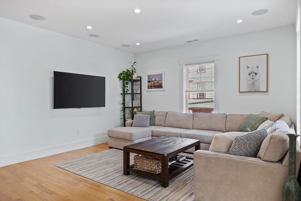 11 Ashland Street, Unit 2 Boston, MA 02122 - Photo 8 of 34 a living room with furniture and a flat screen tv