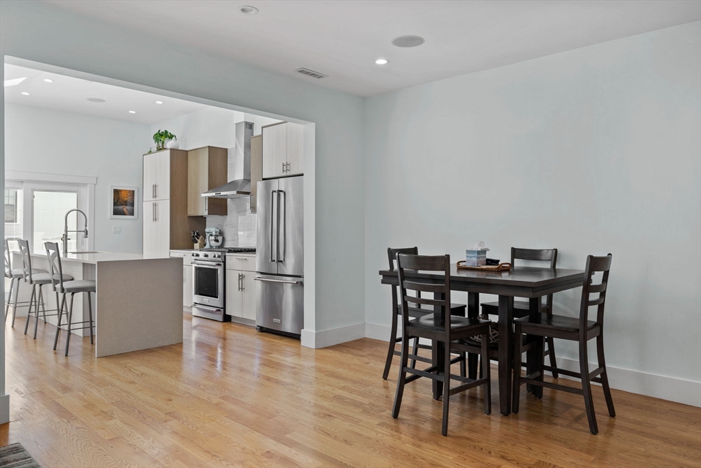 11 Ashland Street, Unit 2 Boston, MA 02122 - Photo 9 of 34 a view of a dining room with furniture and wooden floor