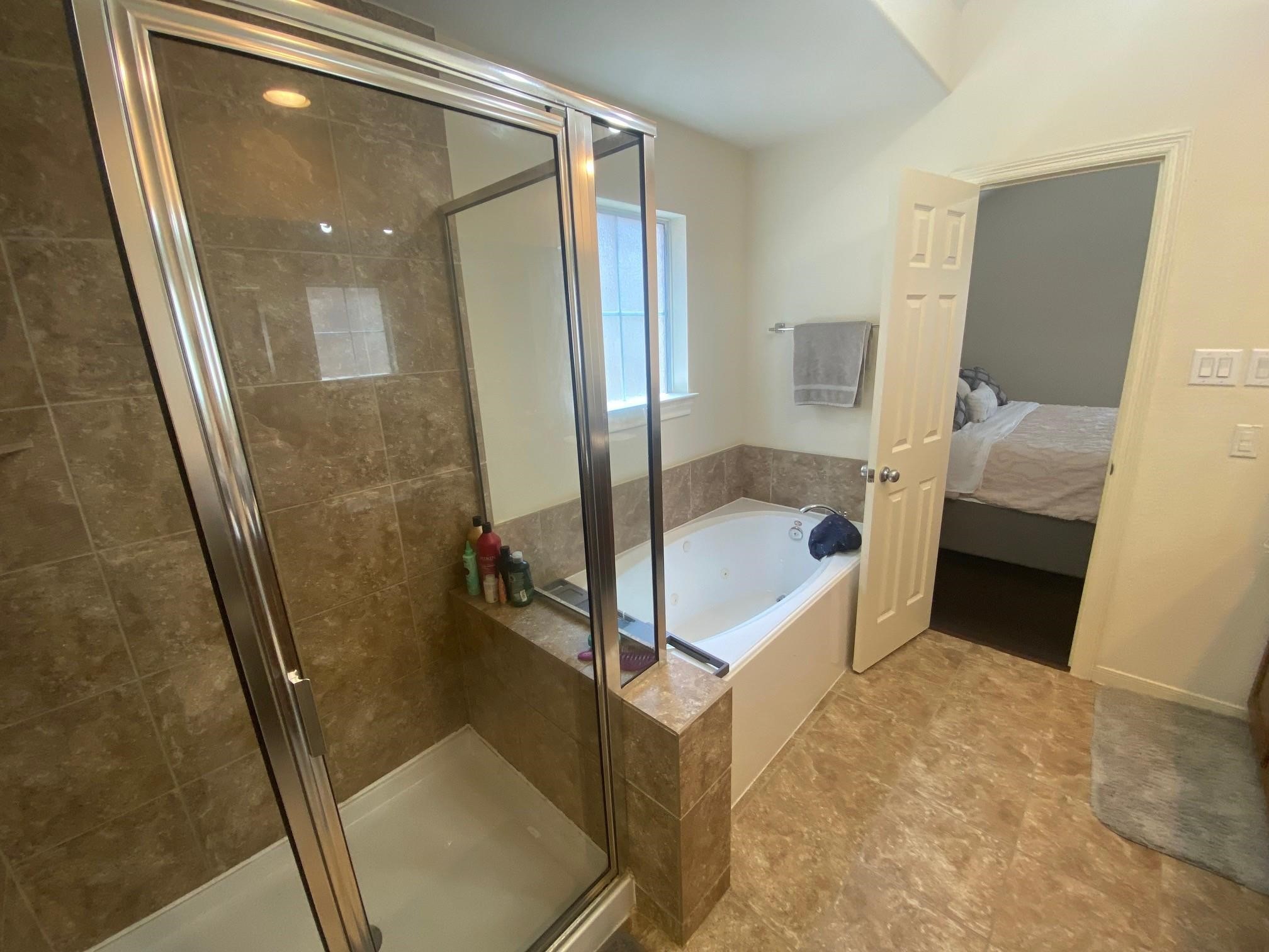3209 Clearview Circle Houston, TX 77025 - Photo 8 of 13 a bathroom with a tub and shower