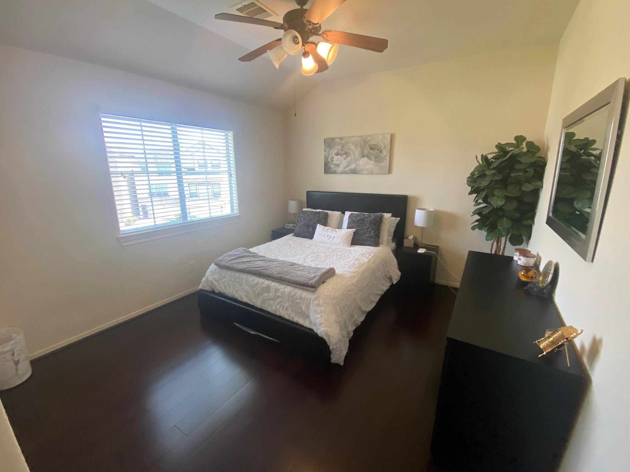 3209 Clearview Circle Houston, TX 77025 - Photo 9 of 13 a bedroom with a bed and a chandelier