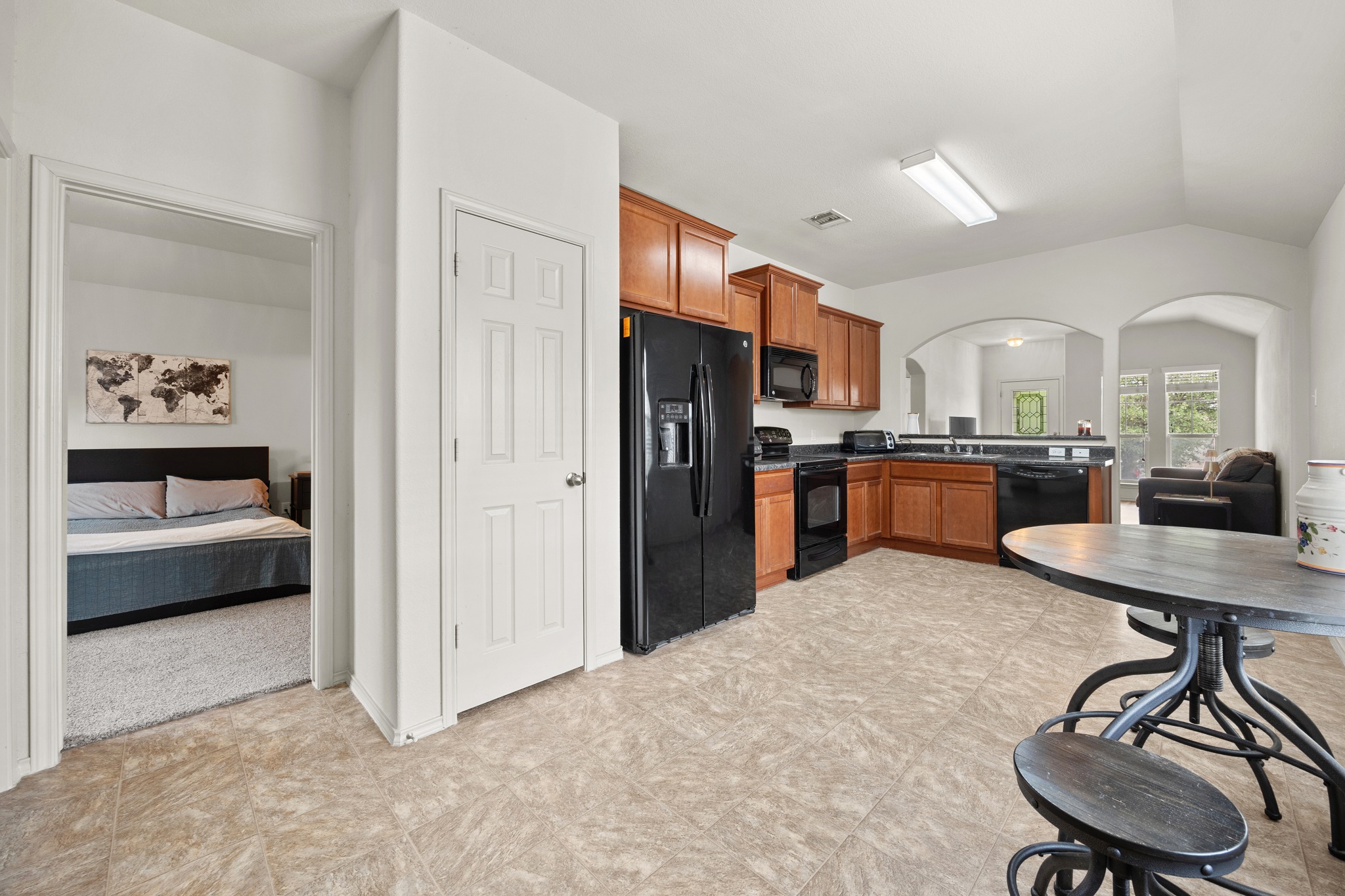 621 Amber Lane Jarrell, TX 76537 - Photo 12 of 22 a kitchen with stainless steel appliances kitchen island a table chairs refrigerator and sink