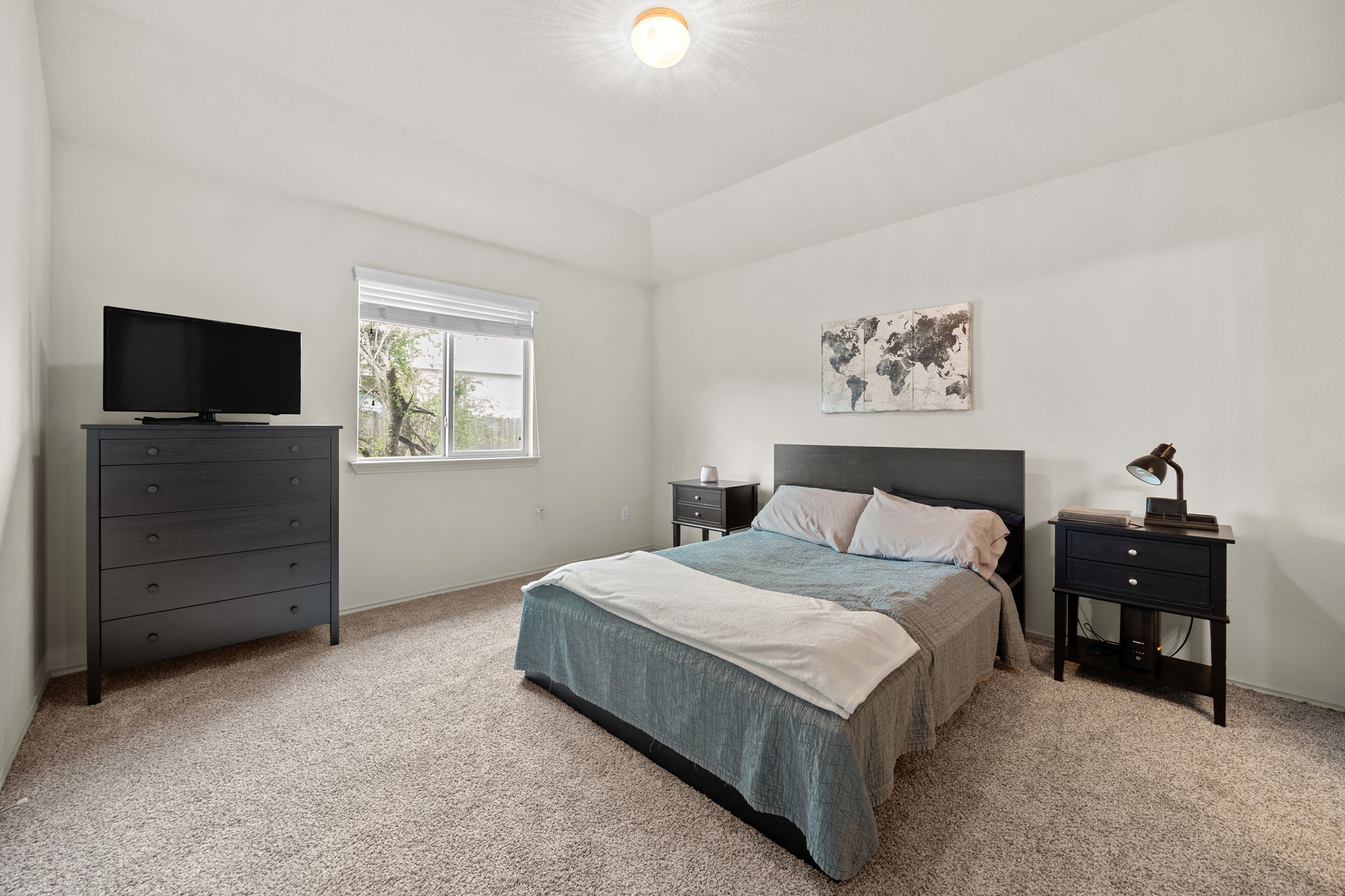 621 Amber Lane Jarrell, TX 76537 - Photo 13 of 22 a bedroom with a bed and a flat tv screen on dresser