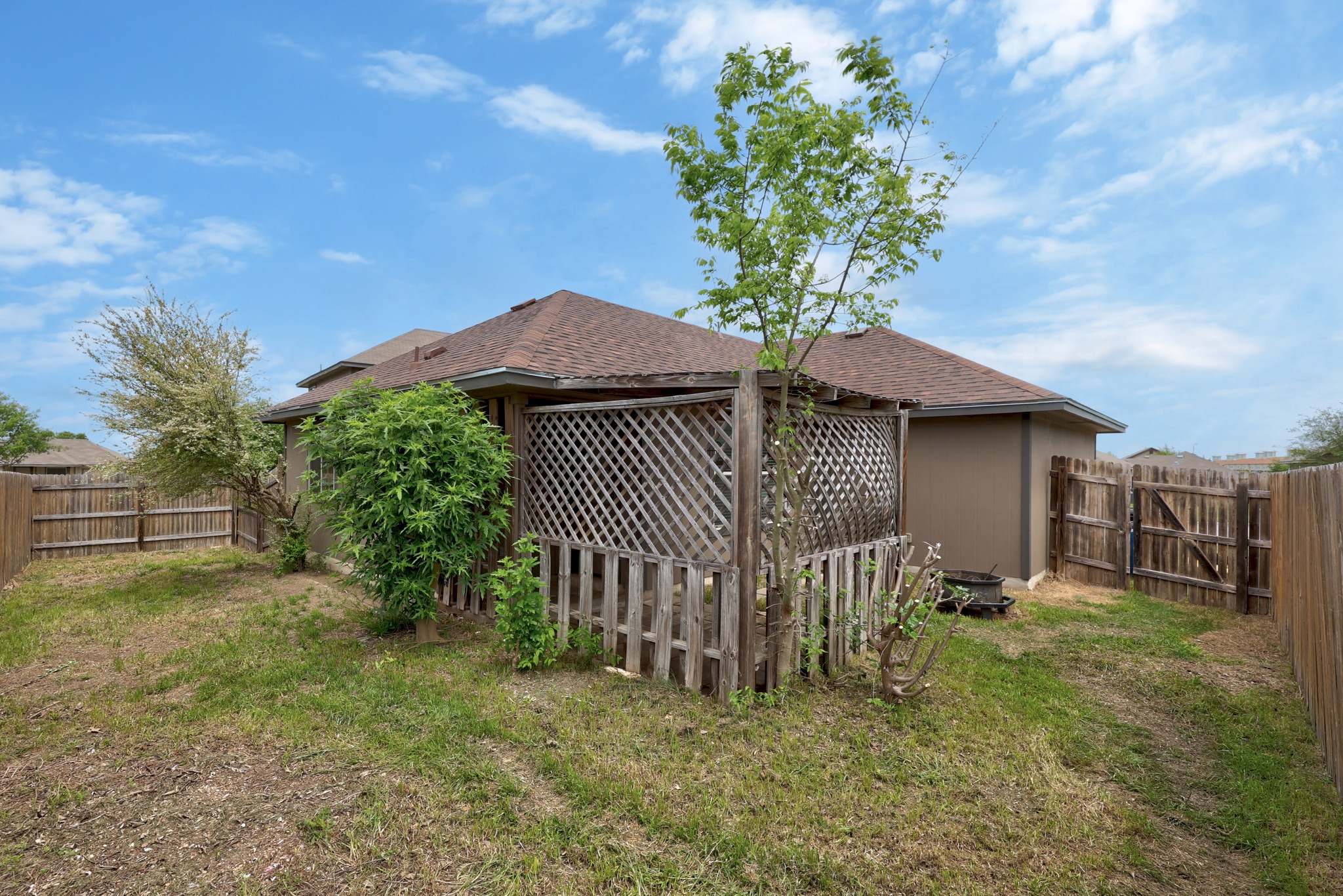 621 Amber Lane Jarrell, TX 76537 - Photo 22 of 22 a backyard of a house with a garden and deck