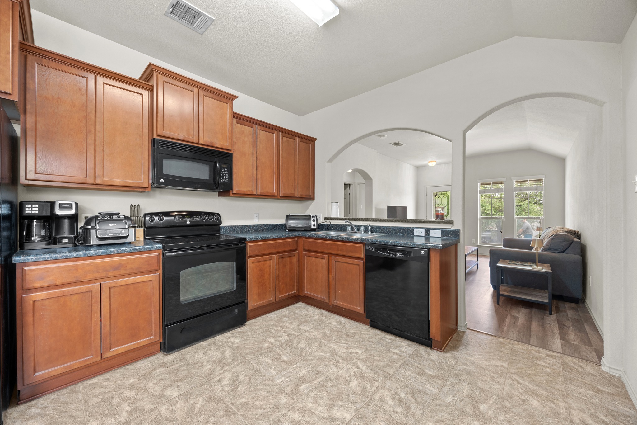 621 Amber Lane Jarrell, TX 76537 - Photo 9 of 22 a kitchen with stainless steel appliances granite countertop a stove sink and cabinets