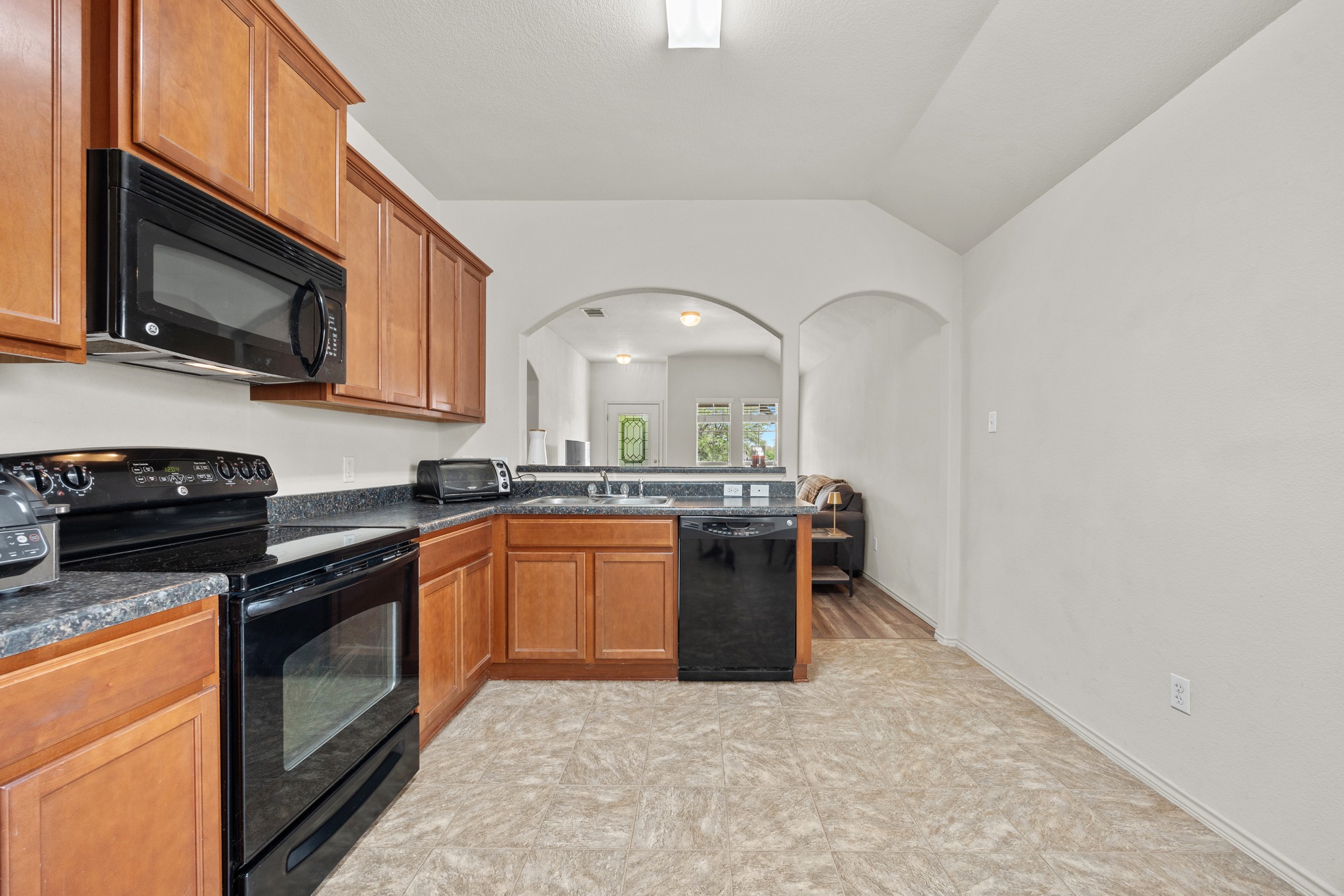 621 Amber Lane Jarrell, TX 76537 - Photo 10 of 22 a kitchen with stainless steel appliances granite countertop a stove a sink and a microwave