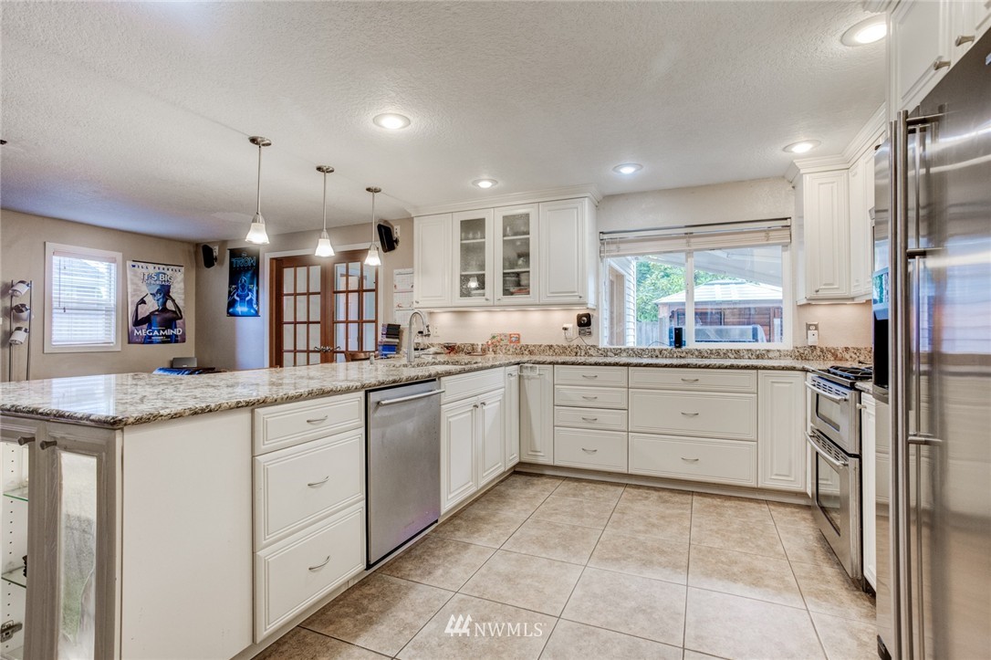 2510 166th Place Southeast Bothell, WA 98012 - Photo 4 of 24 a large kitchen with granite countertop cabinets a washer and dryer