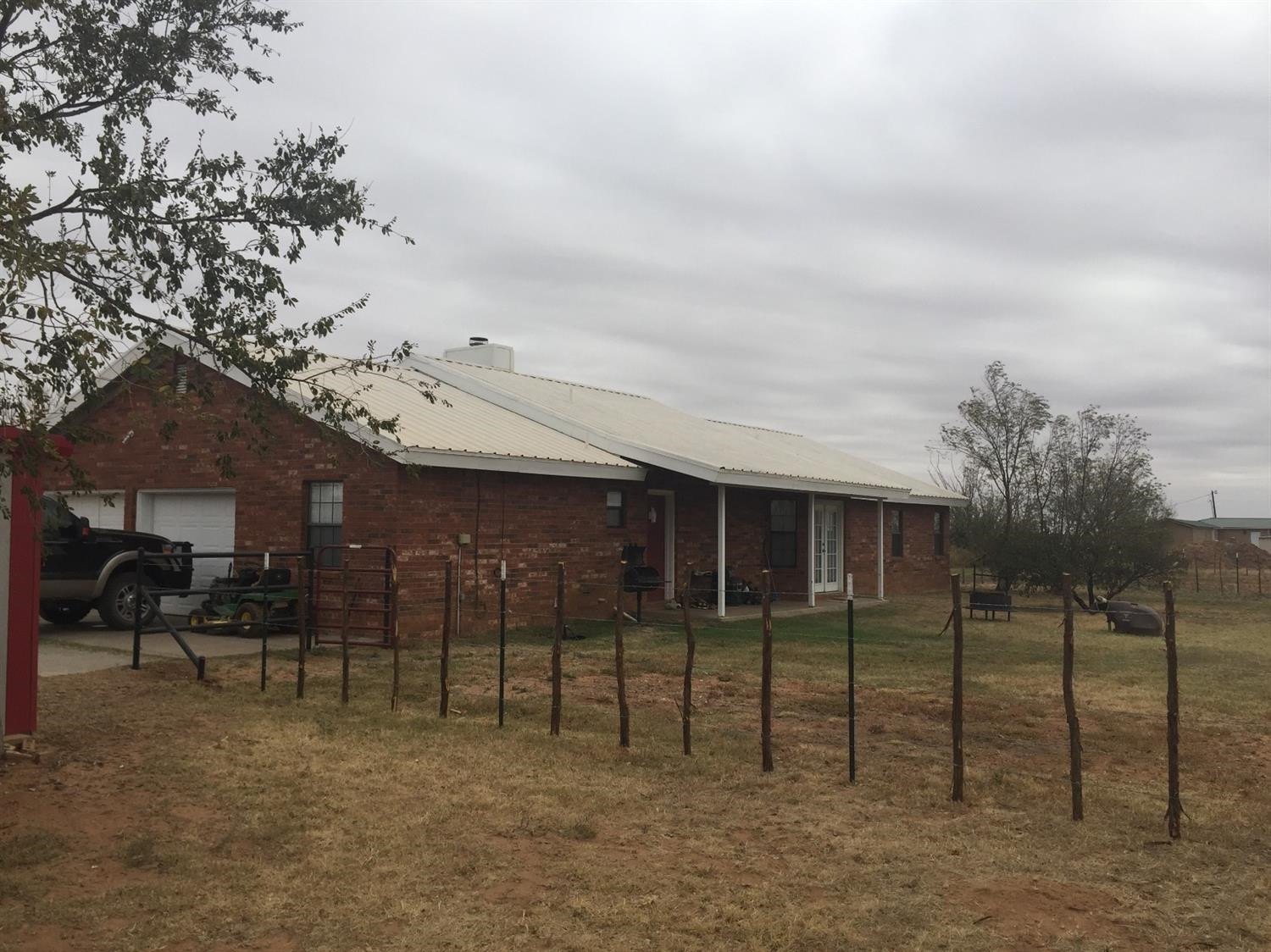 1712 Lovebird Road Lubbock, TX 79407 - Photo 3 of 5 a view of a brick house with iron fence