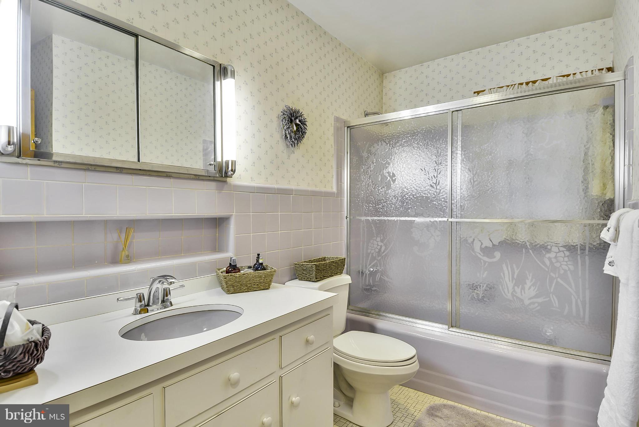 2138 Apple Tree Lane Silver Spring, MD 20905 - Photo 12 of 30 a bathroom with a sink a toilet and a mirror