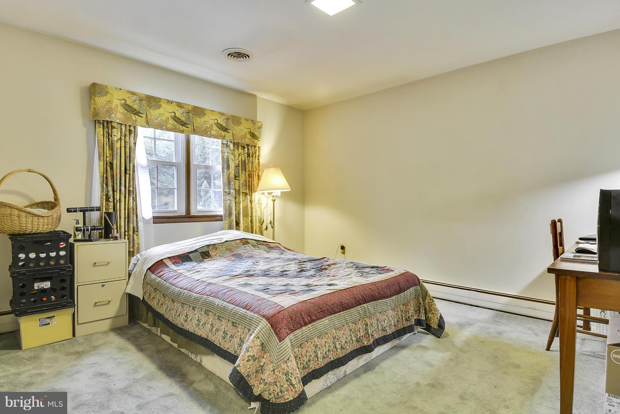 2138 Apple Tree Lane Silver Spring, MD 20905 - Photo 13 of 30 a bedroom with a bed and a dresser