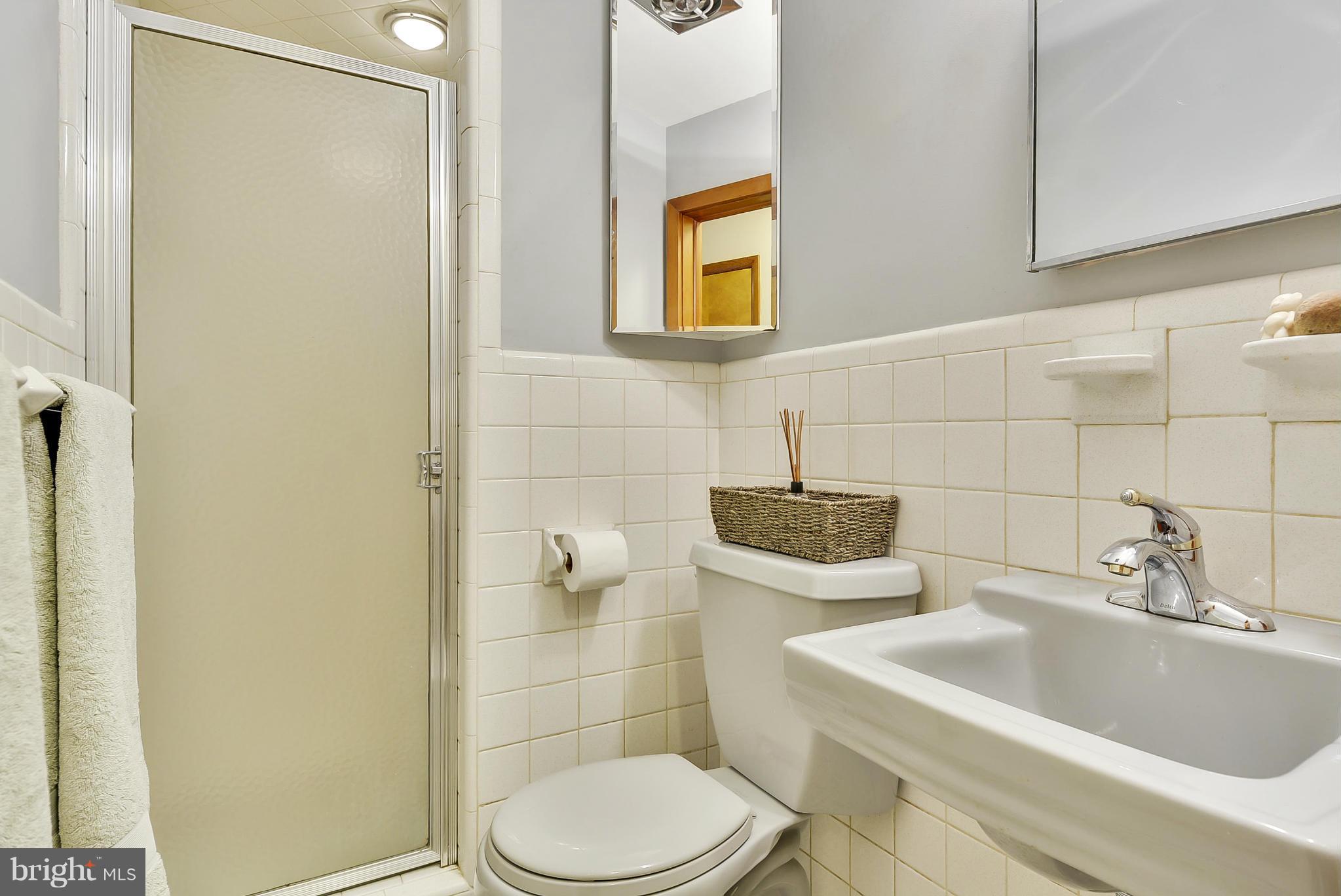 2138 Apple Tree Lane Silver Spring, MD 20905 - Photo 15 of 30 a bathroom with a sink toilet and shower