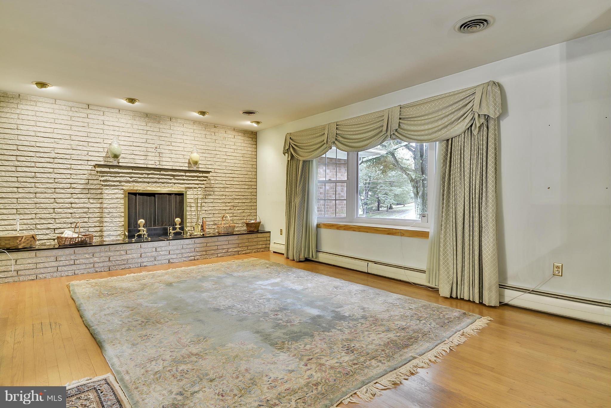 2138 Apple Tree Lane Silver Spring, MD 20905 - Photo 4 of 30 a view of an empty room with a fireplace and a window