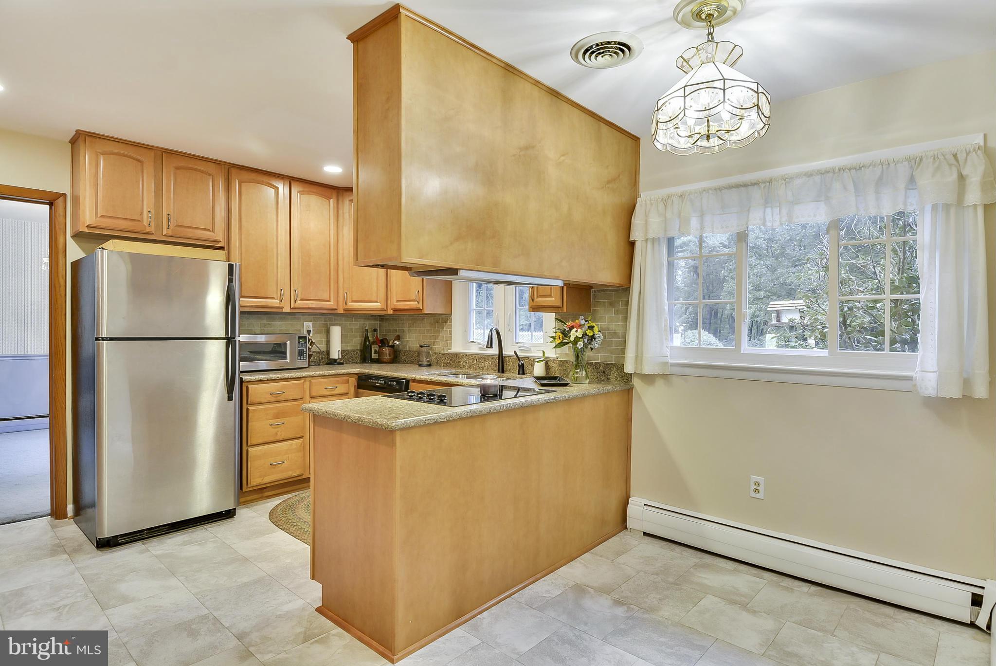2138 Apple Tree Lane Silver Spring, MD 20905 - Photo 8 of 30 a kitchen with stainless steel appliances granite countertop a refrigerator a stove a sink dishwasher and a dining table with wooden floor