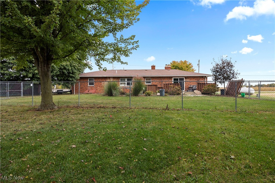 8802 West Mason Road Castalia, OH 44824 - Photo 5 of 49 Back of property with a chimney and brick siding