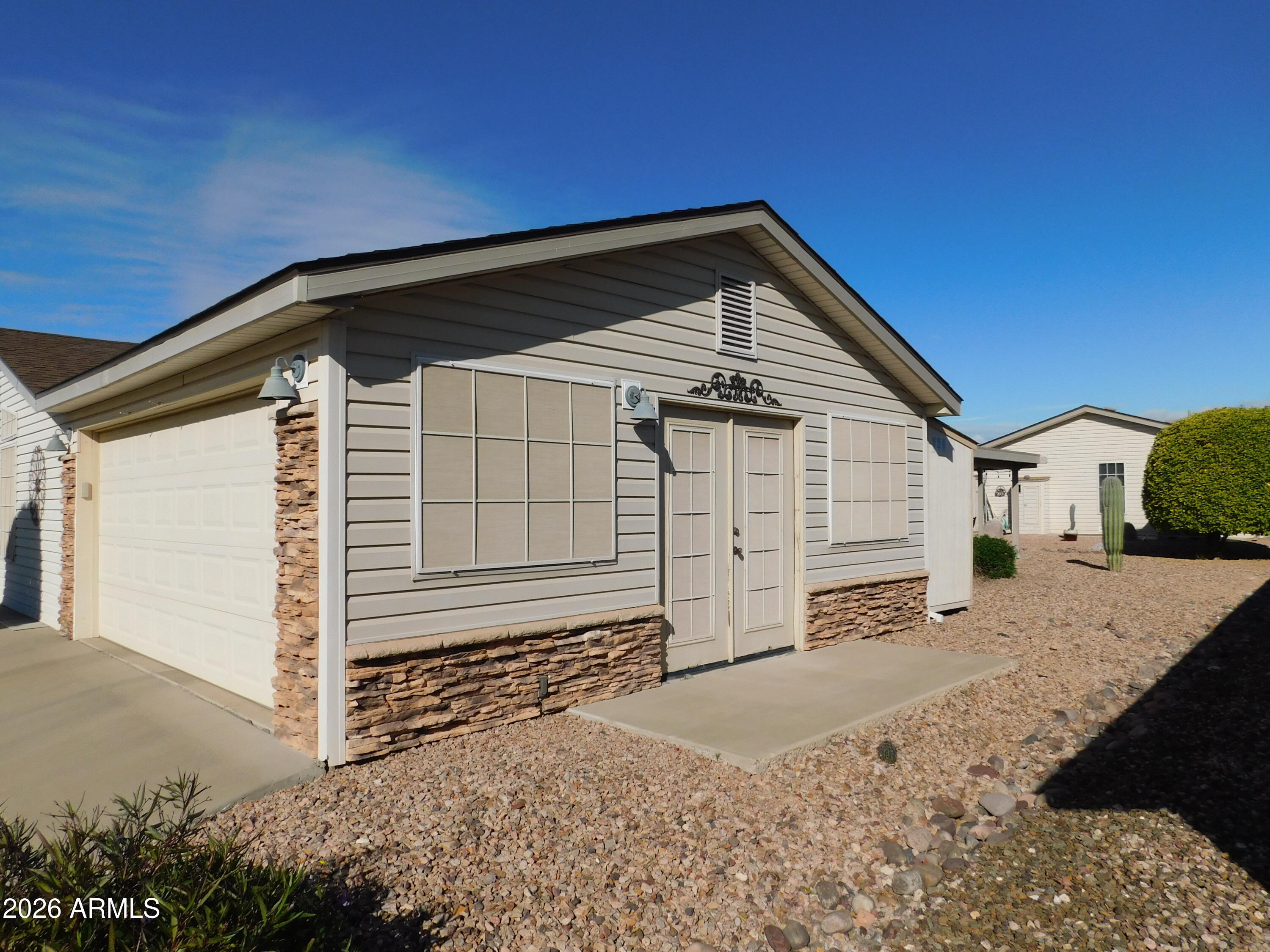 3301 South Goldfield Road, Unit 1054 Apache Junction, AZ 85119 - Photo 11 of 41 a view of a house with a yard